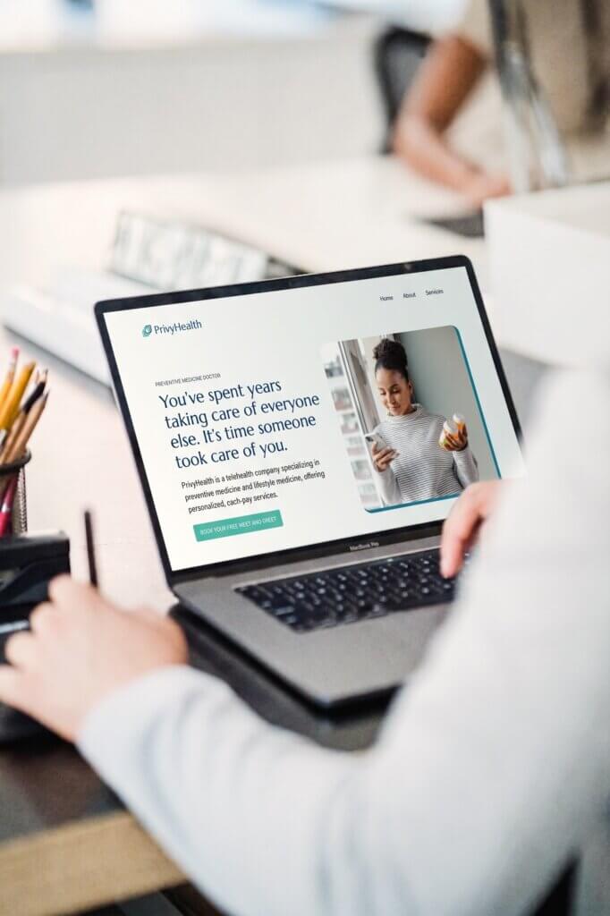 Laptop displaying the PrivyHealth homepage, a health and wellness web design project for a preventive medicine practice