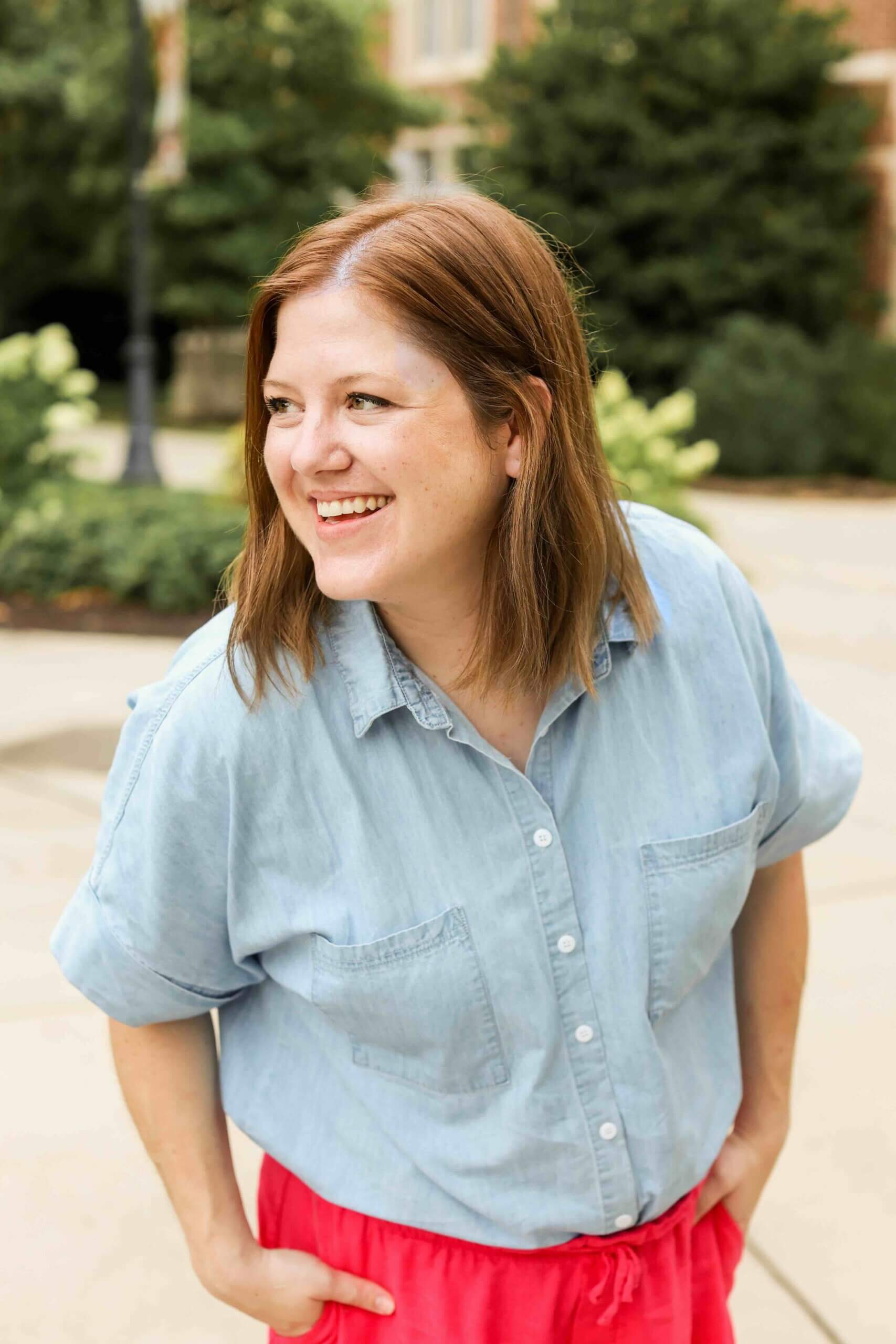 Jess Freeman, the health and wellness website designer behind Jess Creatives, laughing outdoors