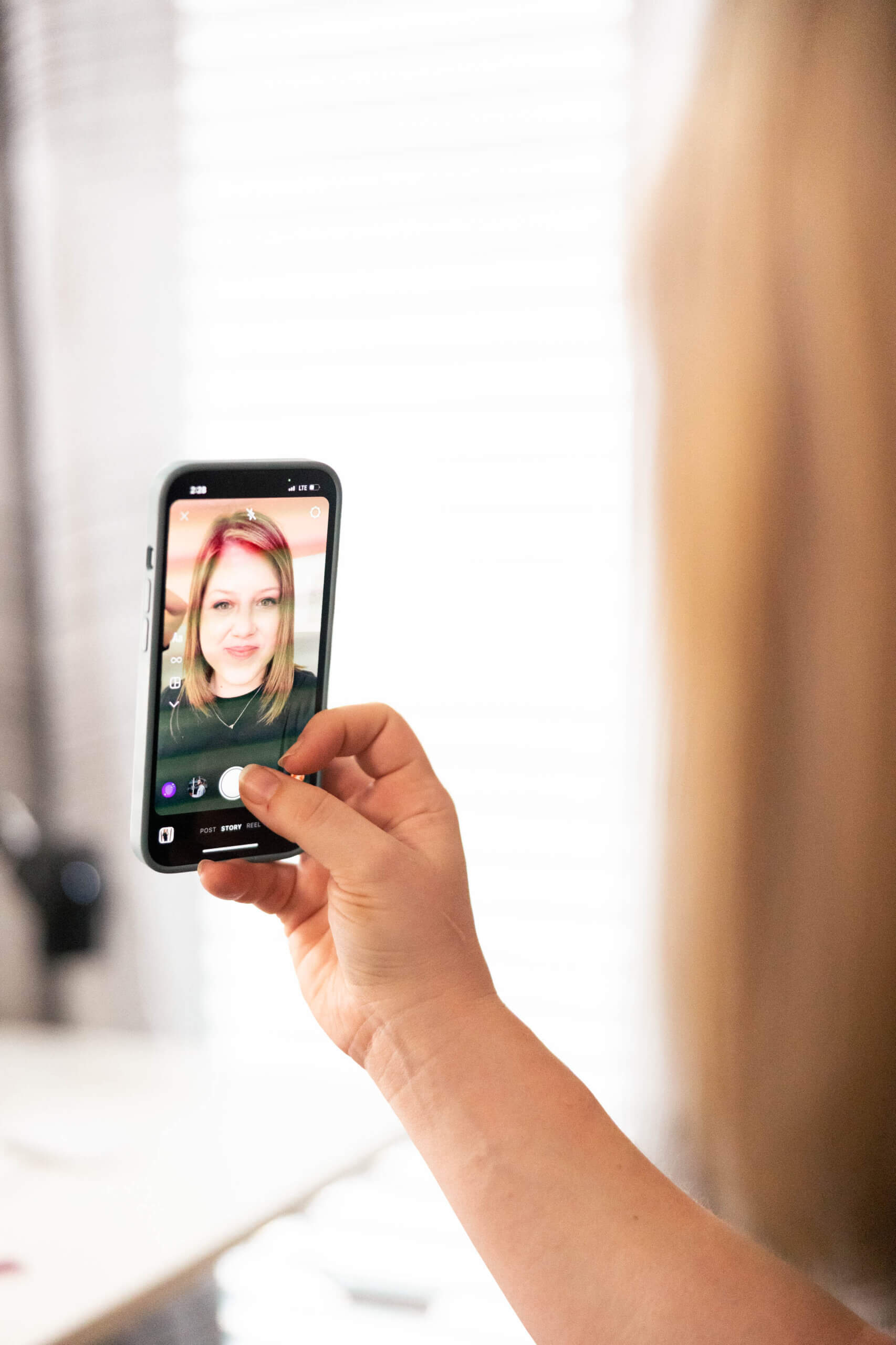 Phone recording a video for the YouTube channel where health and wellness website designer Jess Freeman breaks down SEO and tech