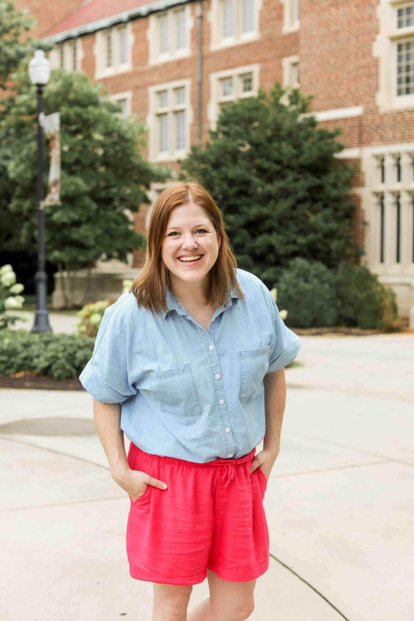Jess Freeman, health and wellness website designer, smiling outdoors at a medical campus