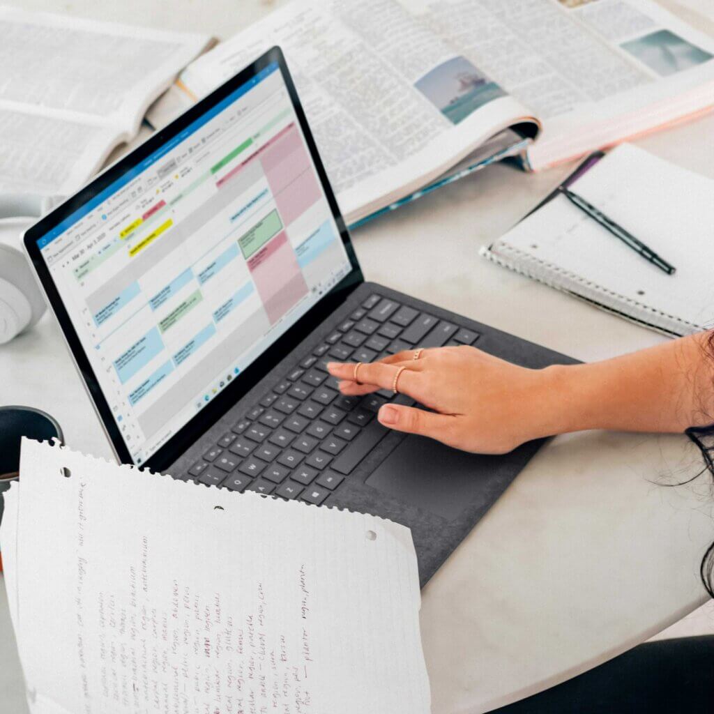 Planning a marketing calendar on a laptop during a session with a web design consultant
