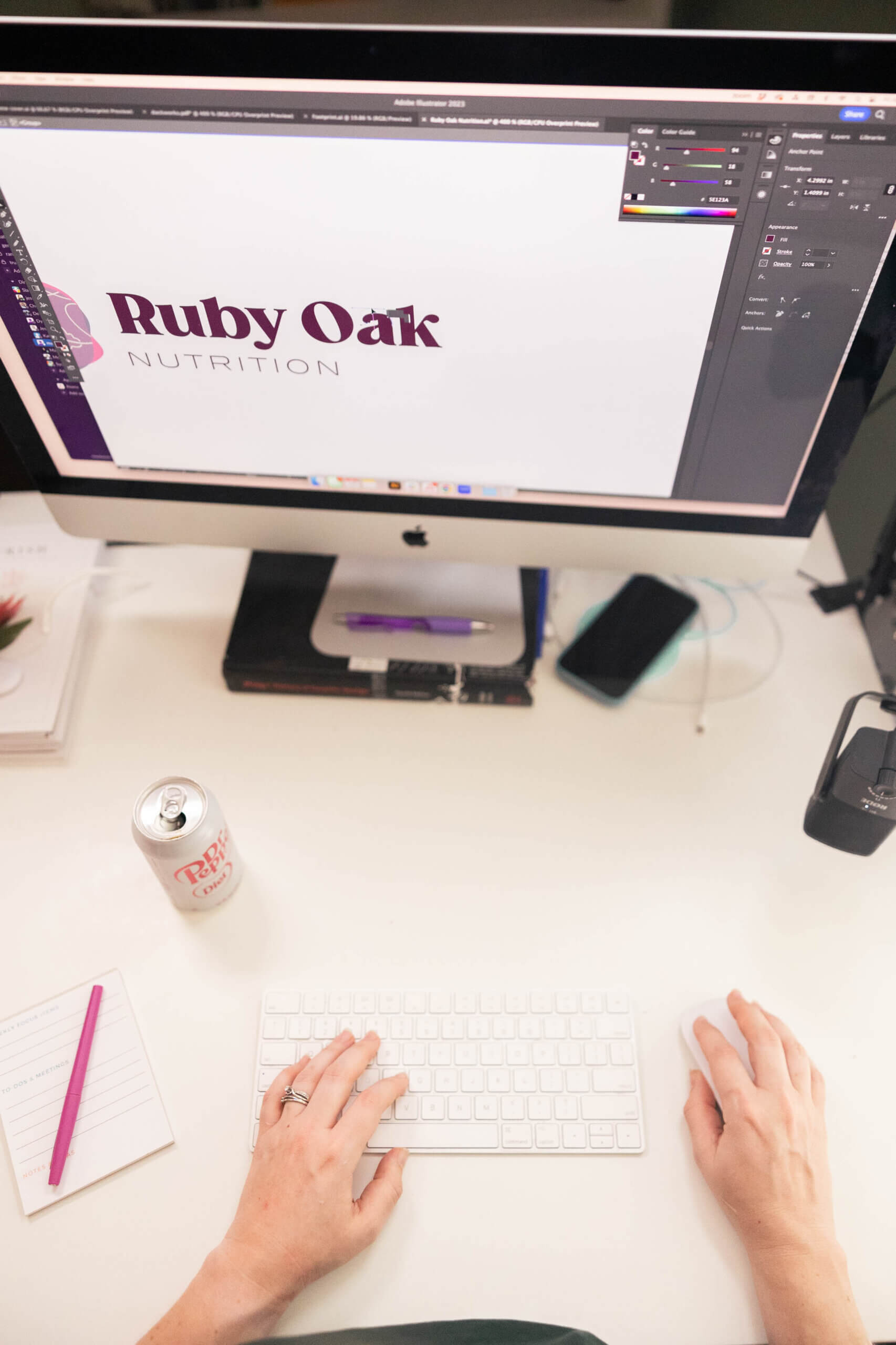Designer refining the a nutrition logo on screen, an example of branding for therapists, dietitians, and medical practitioners